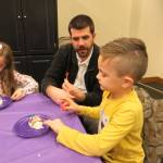 From left, Olivia, Brian and Jack McBride create sugar skulls at the Dia De Los Muertos celebration in downtown Issaquah. Samantha Pak/staff photo