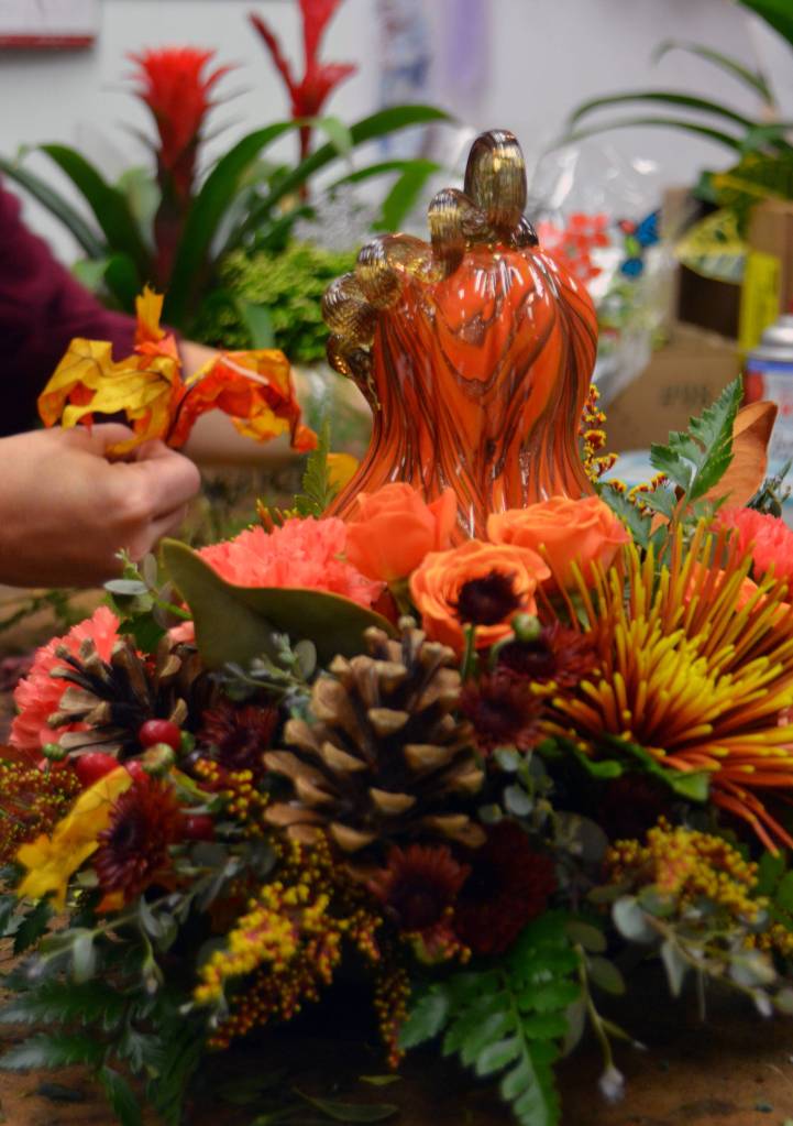 A trend Lisa Aliment has noticed through the years is the fact that people are buying fewer arrangements specific to a home but rather are giving flower designs to friends as gifts during the holidays. Sanura George/staff photo