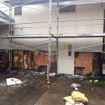 Photo courtesy of the city of Redmond                                 Large scale stucco removal towards the back of the building reveals extensive damage.