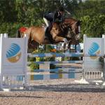 Maggie Nealon clears a jump with Quitello at an equestrian competition. Photo courtesy of SPORTFOT