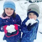 Alivia (left) and Beau Herzog enjoy the snow in Redmond on Monday. Photo courtesy of Katie Herzog