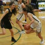 Redmonds Sami Castanos, right, prepares to attack the hoop against Issaquah. Andy Nystrom/ staff photo