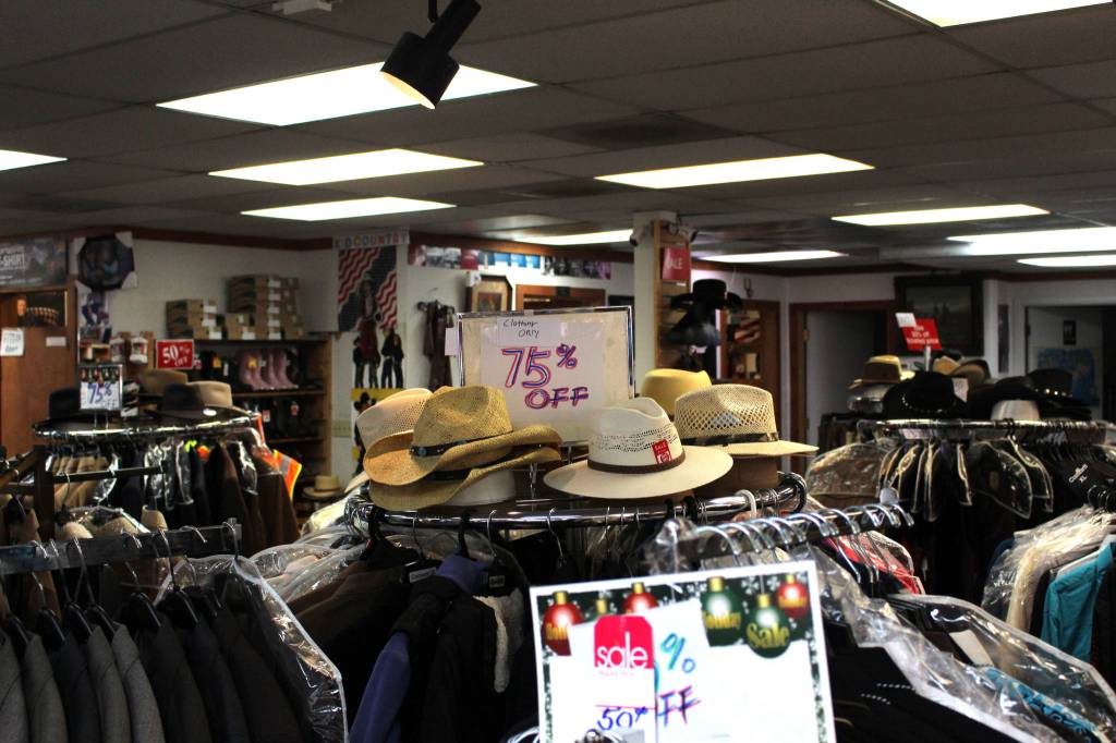 The floor of Redmond Work and Western Wear displaying sale signs in Redmond on March 4. Mitchell Atencio/staff photo