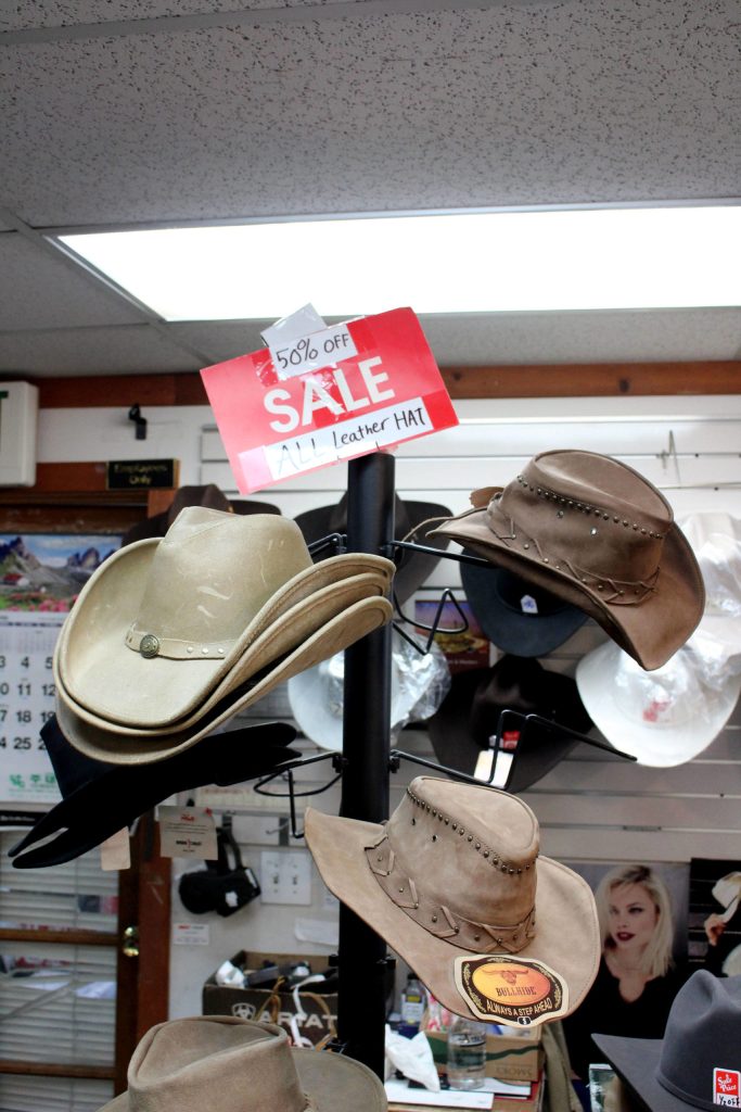A hat display with hats marked 50 percent off at Redmond Work and Western Wear in Redmond on March 4. Mitchell Atencio/staff photo
