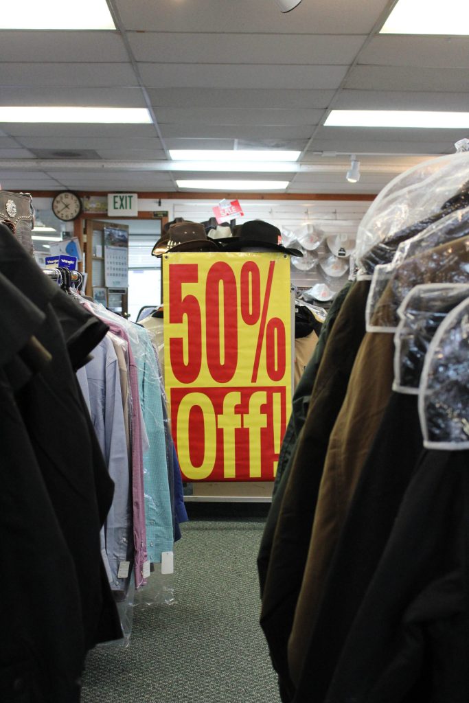 A 50 percent off poster inside Redmond Work and Western Wear in Redmond on March 4. Mitchell Atencio/staff photo