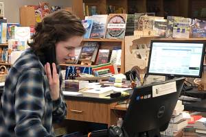 Margaret Hansen works at the counter at Brick & Mortar Books in Redmond Town Center. Photo courtesy of Brick & Mortar Books