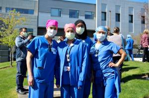 St. Francis Hospital employees pose for a photo, before laughing about smiling behind their masks. Olivia Sullivan/staff photo