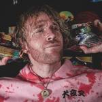 Cassius Marsh holding packs of trading cards (photo credit: Cash Cards Unlimited Instagram)