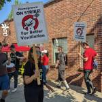 Homegrown Redmond employees hold signs saying Homegrown on strike! For better ventilation after battling a smoky work environment for months. Hannah Saunders / Sound Publishing.