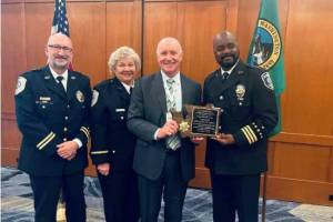 Redmond Police Chief Darrell Lowe (right) accepts award on behalf of the department. (Courtesy of City of Renton)