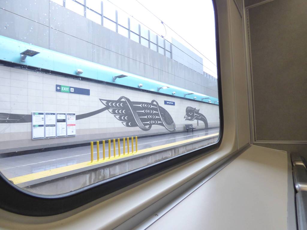 A metal-cut mural depicting a Dragon and Phoenix lines the Spring District Station, situated between the Wilburton and RedBell stations. This mural, created by Chinese-indigenous artist Louie Gong, is a mixture of Coast Salish and Chinese paper-cutting designs. According to Gong, this art represents the experience of mixed-race people. (Cameron Sires/Sound Publishing)