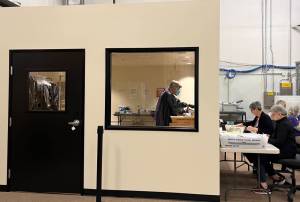 Election workers open mail in a new secure room at Thurston Countys elections office. The county invested in a separate room to open mail after it was sent an envelope containing fentanyl last year. (Laurel Demkovich/Washington State Standard)