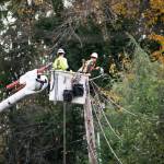PSE crews do a hire-wire act to help restore power. COURTESY PHOTO, PSE