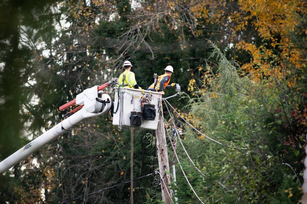 PSE crews do a hire-wire act to help restore power. COURTESY PHOTO, PSE