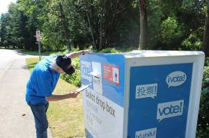 A man places his ballot into the drop box outside Federal Way City Hall. Bailey Jo Josie/Sound Publishing