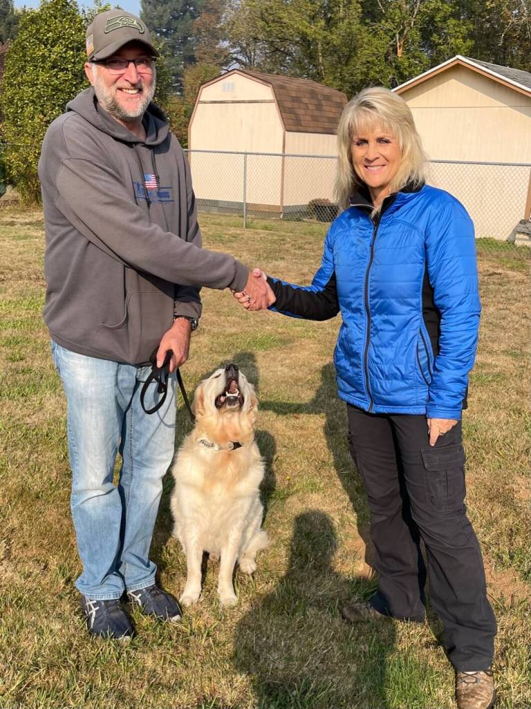 Northwest Battle Buddies founder and CEO Shannon Walker shakes hand with Charles and Dodger, his Battle Buddy. Photos courtesy of Northwest Battle Buddies